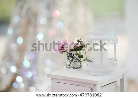 small bouquet of pink flowers stands on a table