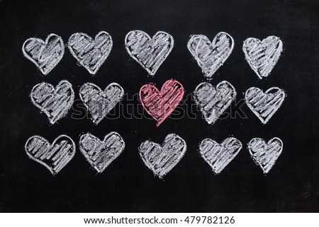 Drawing red heart and white heart on the blackboard