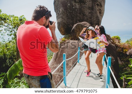 young company of friends sightseeing, taking pictures, traveling in Thailand, holding map, posing for photographer, summer vacation