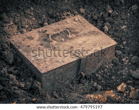 Old metal chest with the treasure found in the ground Royalty-Free Stock Photo #479795197