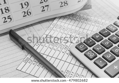 Pens, calendars and calculator  . Black and white photography.