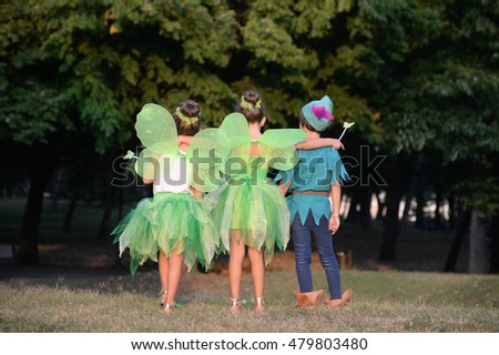 Boy dressed as Peter Pan and two girls in fairy costume