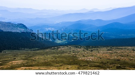 View on a mountains and hills with green grass on it and blue sky. Colorado. Mountain Evans. Denver. USA