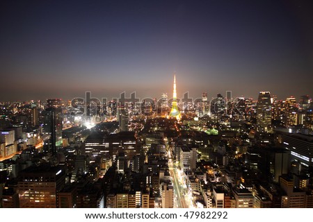 Tokyo Tower among the night skyline of Tokyo, Japan during sunset