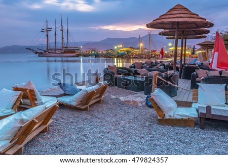 Relaxing facilities and pleasure vessels at the central beach of Eilat - famous resort and recreation city in Israel Royalty-Free Stock Photo #479824357