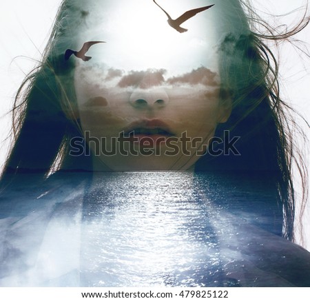 Double exposure portrait of a young woman combined with photograph of nature ocean, clouds and flying birds