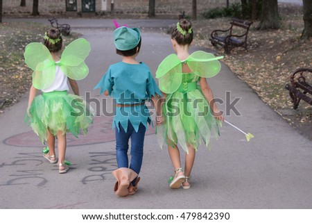 Boy dressed as Peter Pan and two girls dressed as fairies