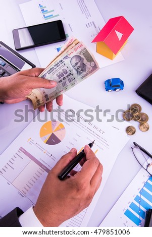 India and accounting concept showing accountant working on Income tax forms or on budget planning with currency notes, calculator and house/car 3d Models