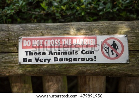 Do not cross the barrier, these animals can be very dangerous sign