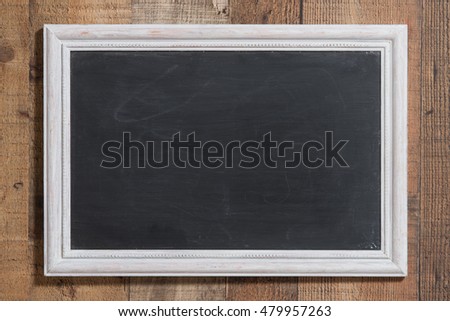 Used chalkboard set in a white distressed frame on barn wood