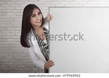 Asian business woman holding blank board, you can put your design on it, success people concept