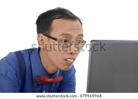 Nerd man using laptop look concentration, isolated over white background