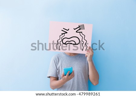 man holding cry expression billboard and take phone isolated on blue background