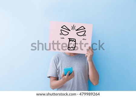 man holding angry expression billboard and take phone  isolated on blue background