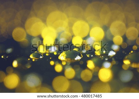 drop of water bokeh lights gold background