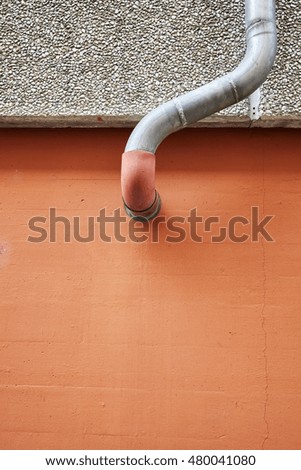Close up picture of old wall with gutter or pipe, abstract architecture background.