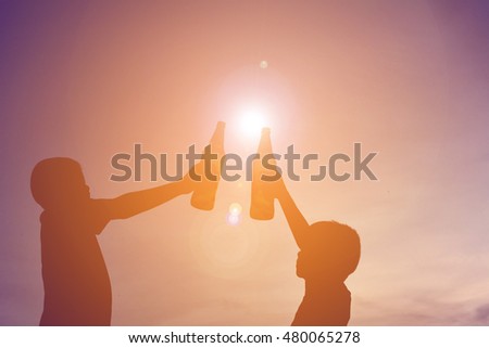 Silhouette hand holding bottle