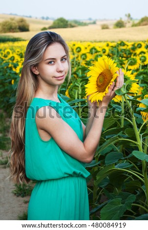 Beautiful  girl on the field of sunflowers