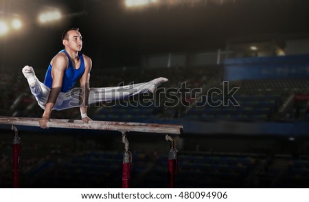 portrait of young man gymnasts competing in the stadium