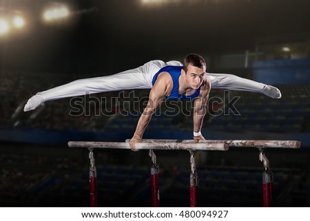 portrait of young man gymnasts competing in the stadium