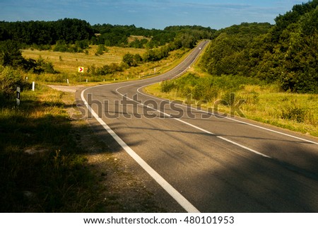 road in forest in autumn. Picture of empty countryside road. Asphalt highway