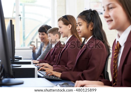 Pupils In Computer Class With Teacher Royalty-Free Stock Photo #480125899