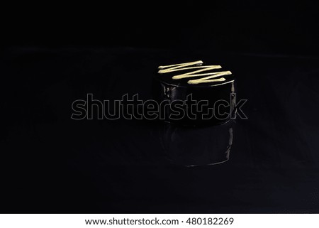 black chocolate dessert on a black background. Dark Picture, minimalism
