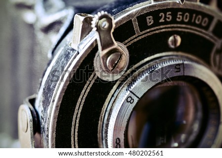 closeup of the lens of an old folding camera