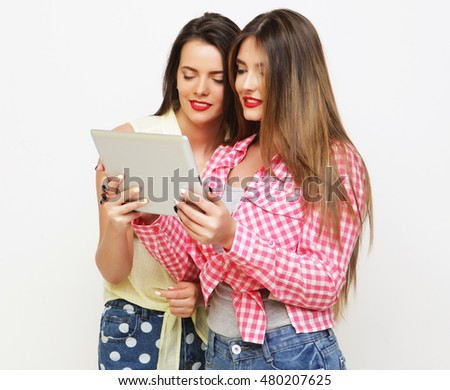 two girls friends taking selfie with digital tablet