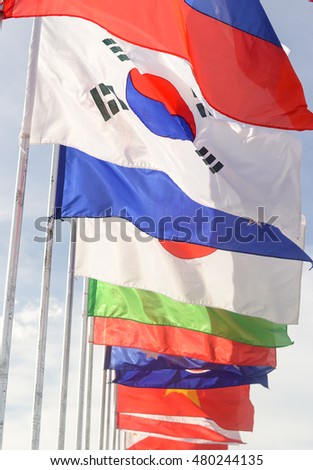 group of united flags on a blue sky background