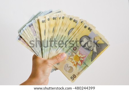 Woman holding money. Romanian national currency Royalty-Free Stock Photo #480244399