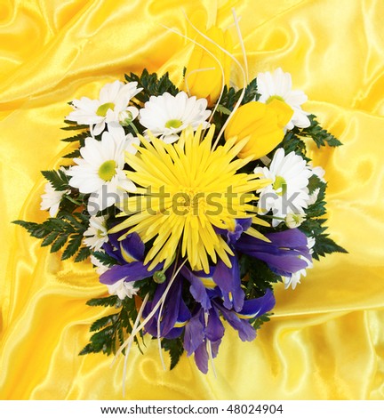 Elegant bouquet shot from above on yellow textile