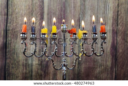 Chanukah candles all in a row. Bright, shiny multicolor candles for the Jewish holiday.