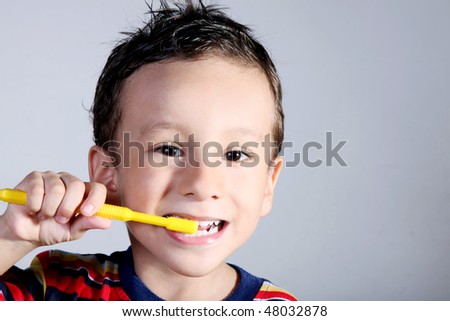 A four year old child brushing his teeth. Oral care