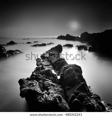 The voice of the sea,
Tropical rocky beach at sunrise in black and white, A slow shutter speed was used to see the movement of the clouds in the sky.
