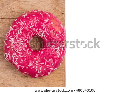 Bright, fresh, sweet donut on a cutting Board on white background isolated. Top view with place for text.