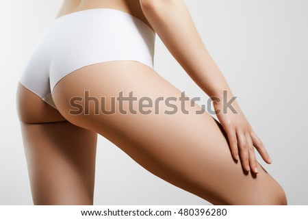 Beautiful slim woman's body. Perfect slim toned young body of the young girl. Fitness or plastic surgery and aesthetic cosmetology. Perfect buttocks Royalty-Free Stock Photo #480396280