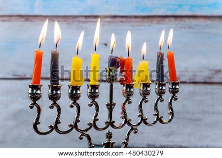 jewish holiday Hanukkah with menorah traditional and wooden dreidels spinning top . glitter overlay