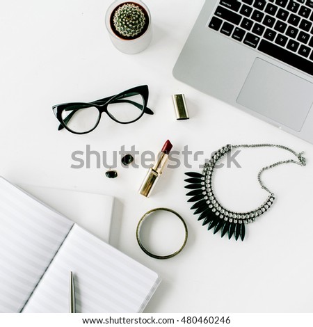 Flat lay, top view office desk. Workspace with laptop, feminine accessories, glasses, cactus, diary, lipstick, necklace on white background.