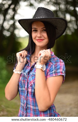 Young american cowgirl woman portrait outdoors.