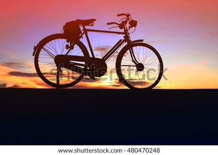 Silhouette of bicycle in the morning at the beach waiting for the sunrise.