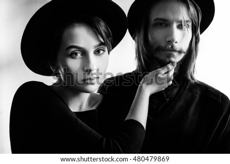 interesting young woman and man looking at the camera