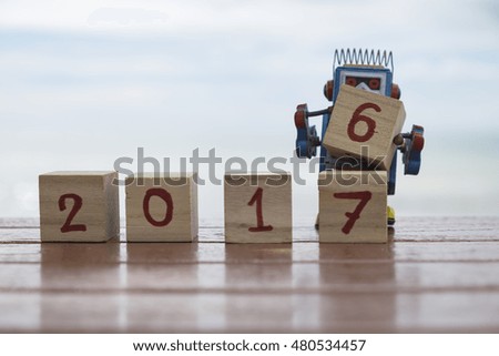 Wooden cubes with 2017 on table, new year template