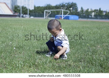Cute Chinese baby boy playing in a stadium, Beijing, China