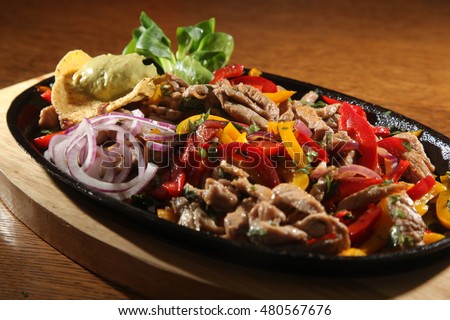 beef fajita in pan on wooden table