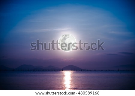 Fantastic view of the sea. Romantic scenic with full moon on sea to night. Reflection of moon in water. Vignette picture style. The moon were NOT furnished by NASA.