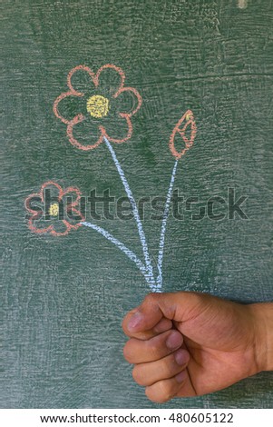 man holding flower on chalkboard