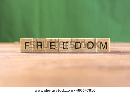 the word of FREEDOM on wood tiles concept
