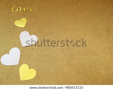Love. Craft love. Golden love. Golden paper heart. Craft background for you text. Love word. Love caligraphic. 