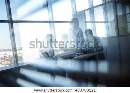 Business colleagues working behind blinds